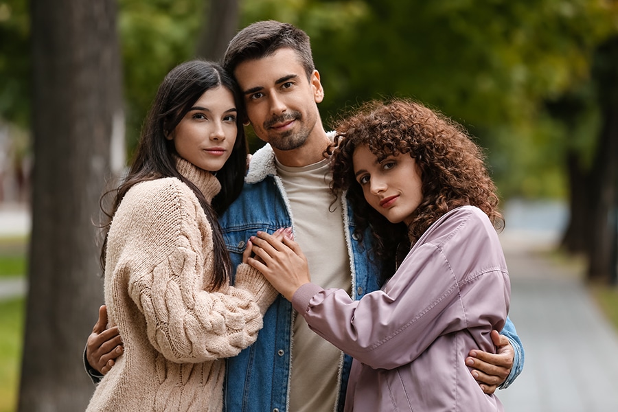 A polygamous throuple enjoying the benefits of polygamy.